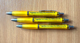 Three yellow pens on a table with 'together we make the difference' written on them